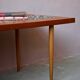 1970s coffee table with a tapered teak base and ceramic mosaic.