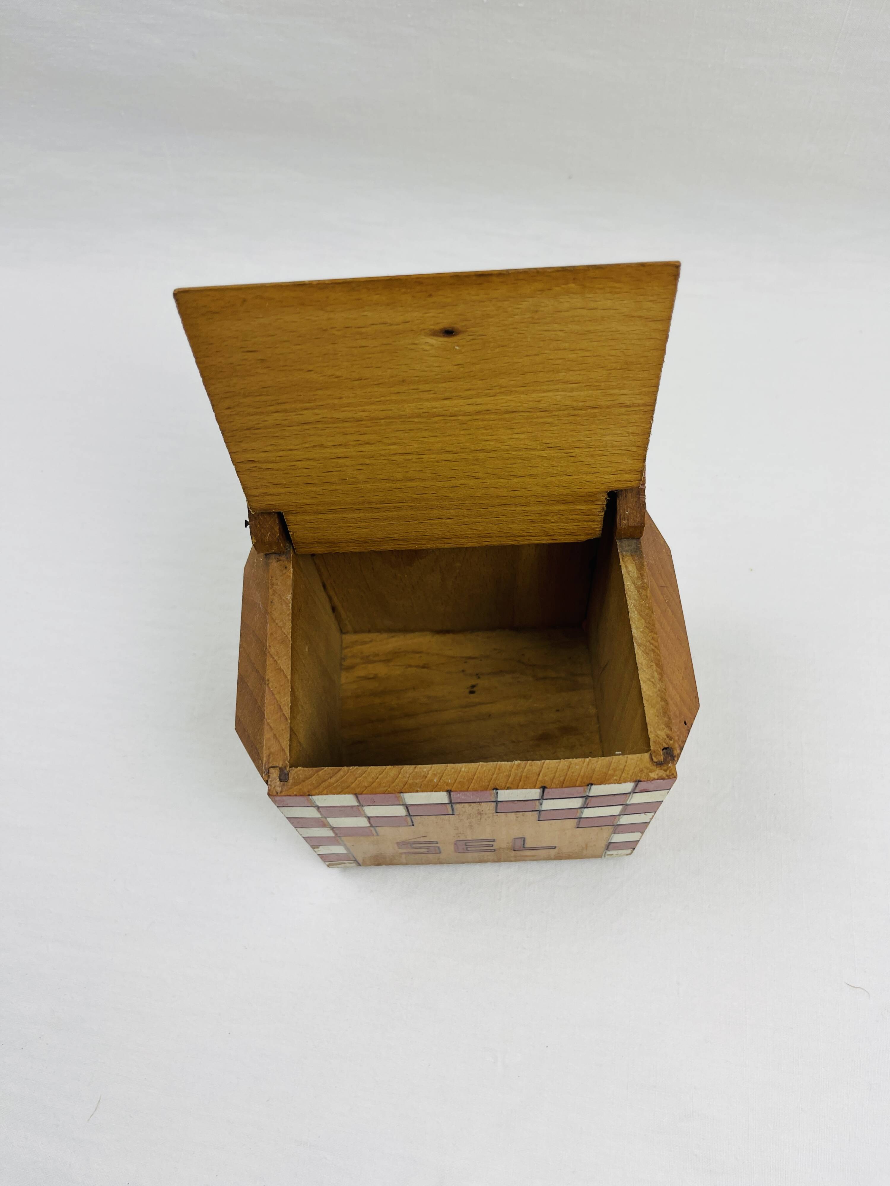 Old wooden salt box with red and white checkerboard decoration