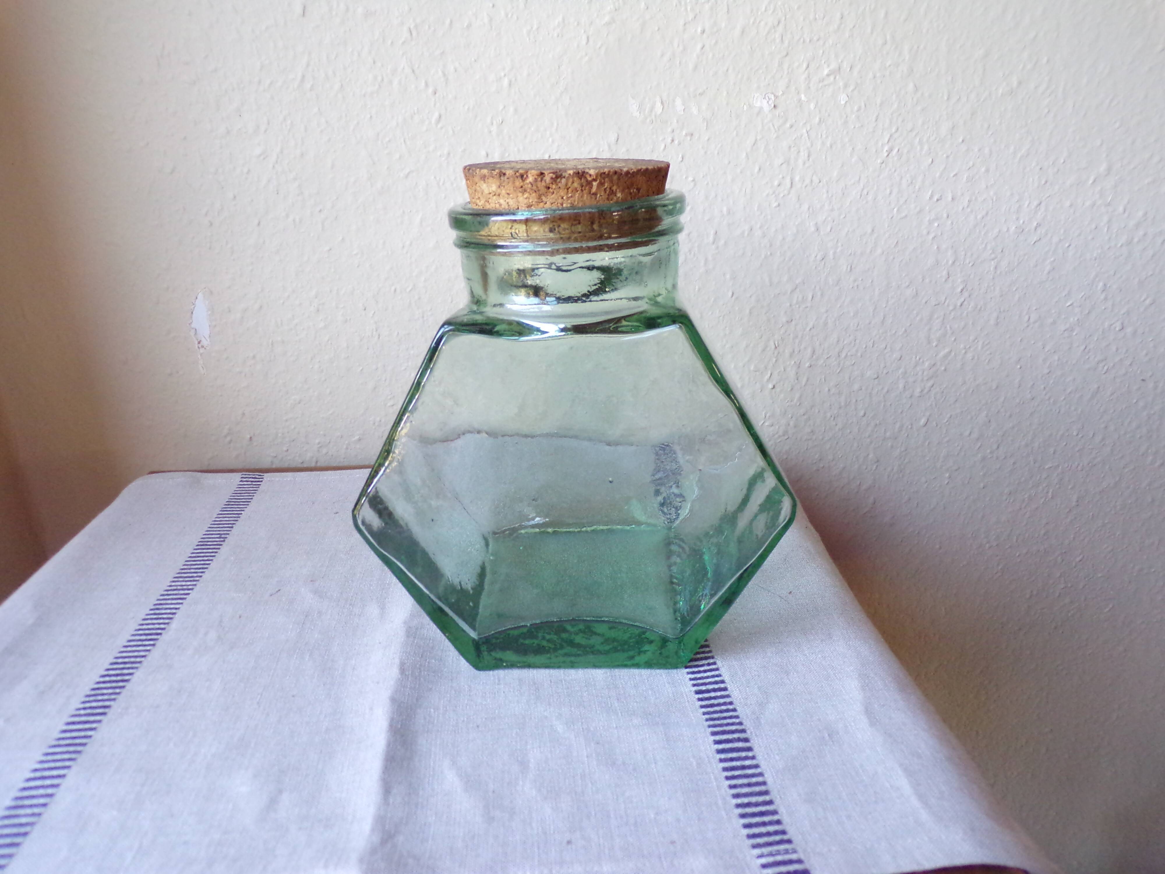 Old thick glass of a light green jar