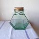 Old thick glass of a light green jar