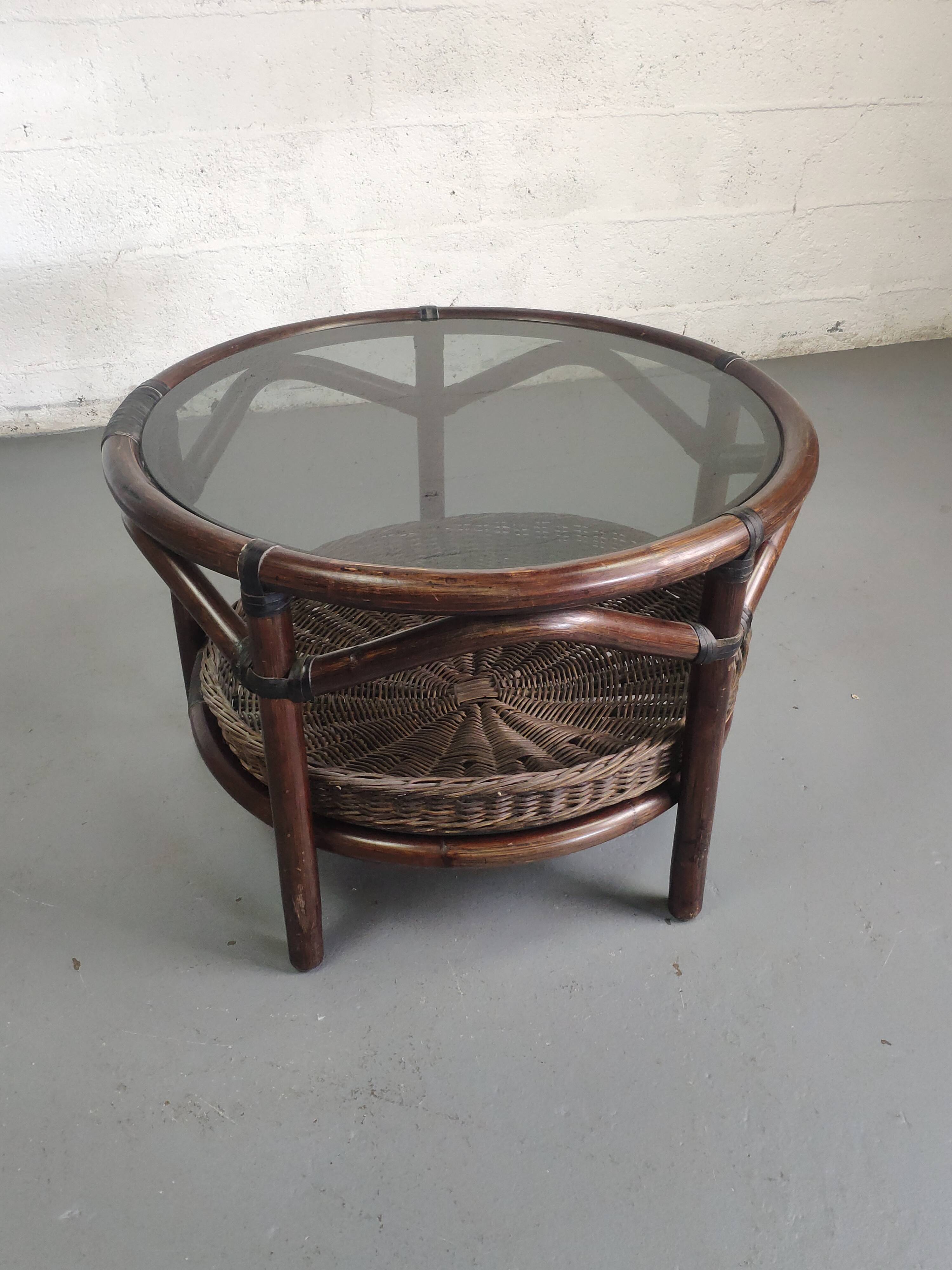 Vintage rattan coffee table with smoked glass top and rattan basket shelf