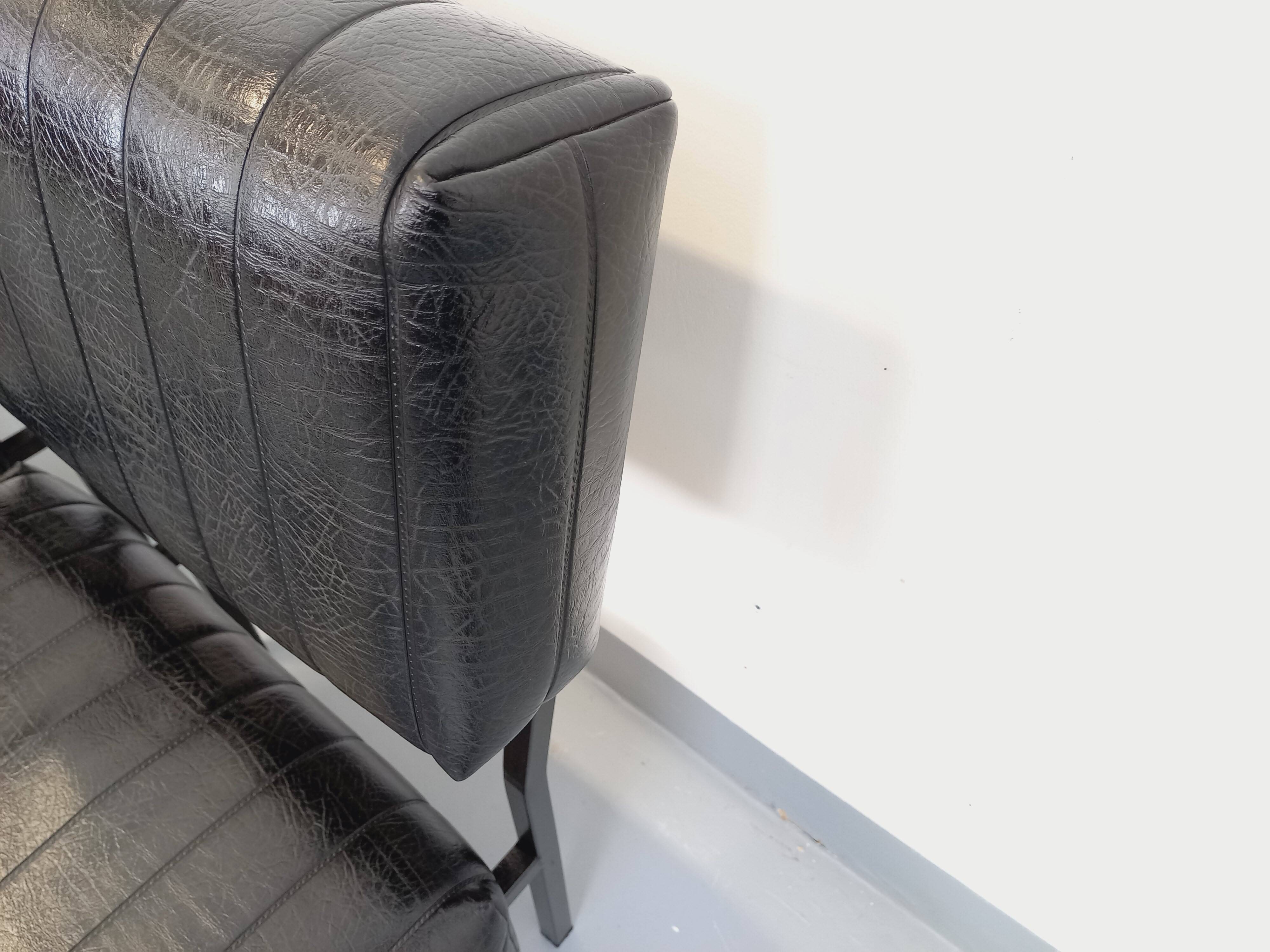 Set of 2 vintage modernist armchairs in black faux leather and metal.