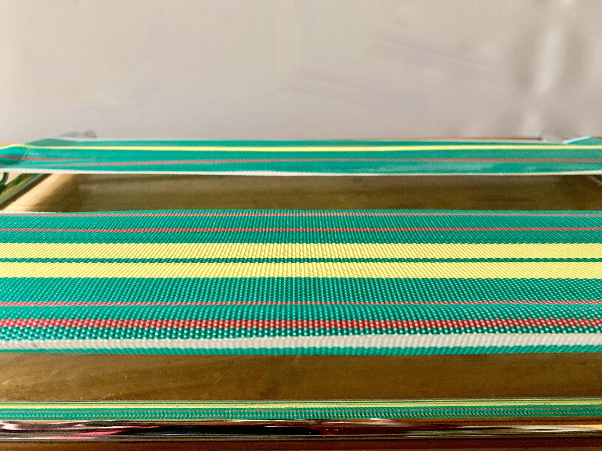 Vintage folding beach chair in chrome metal and woven plastic