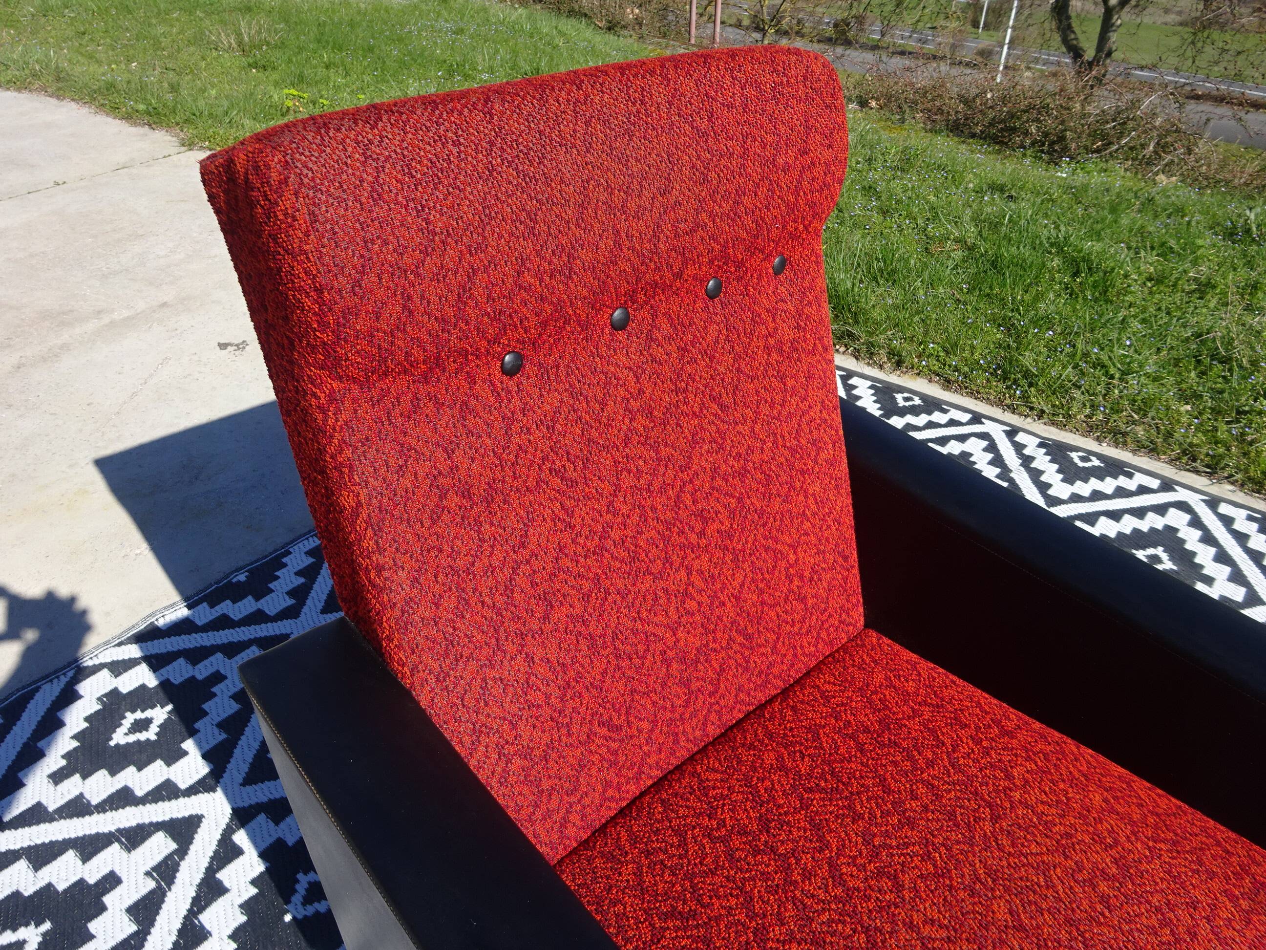 Vintage armchairs in red and black faux leather, the pair.
