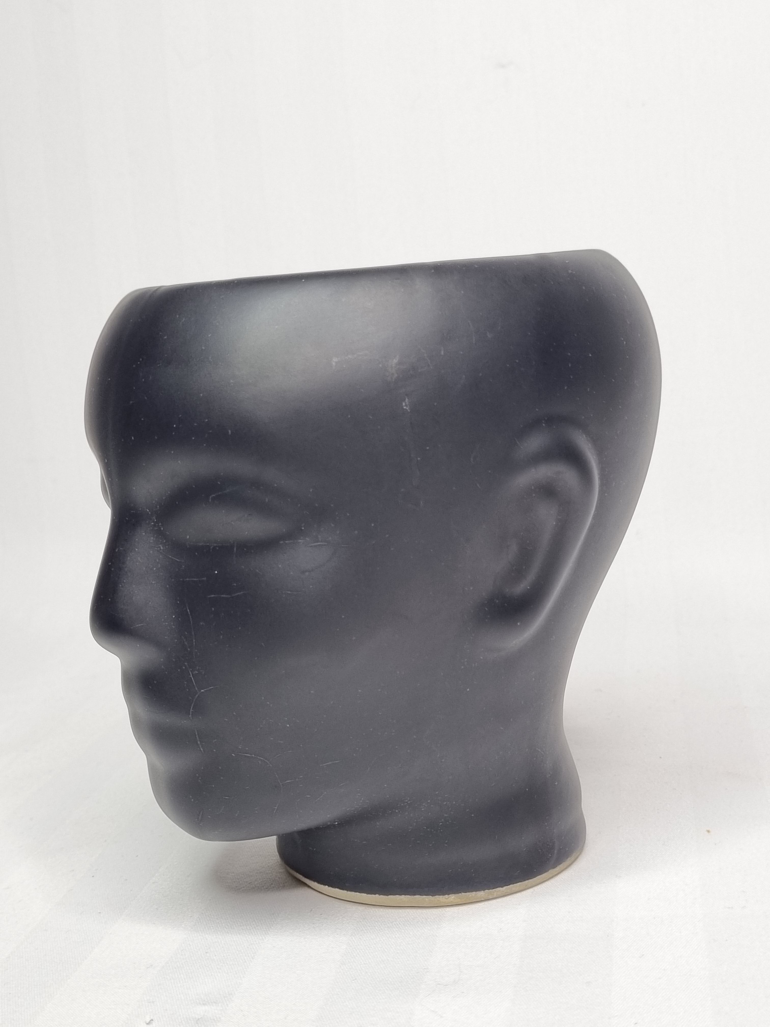 Anthropomorphic pot cover in matt black glazed ceramic, 80s