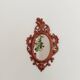 Classic red and gold patinated rocaille mirror, 35 cm x 23 cm
