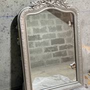 Large antique mirror from the late 19th century with a sculpted pediment in Louis Philippe style.