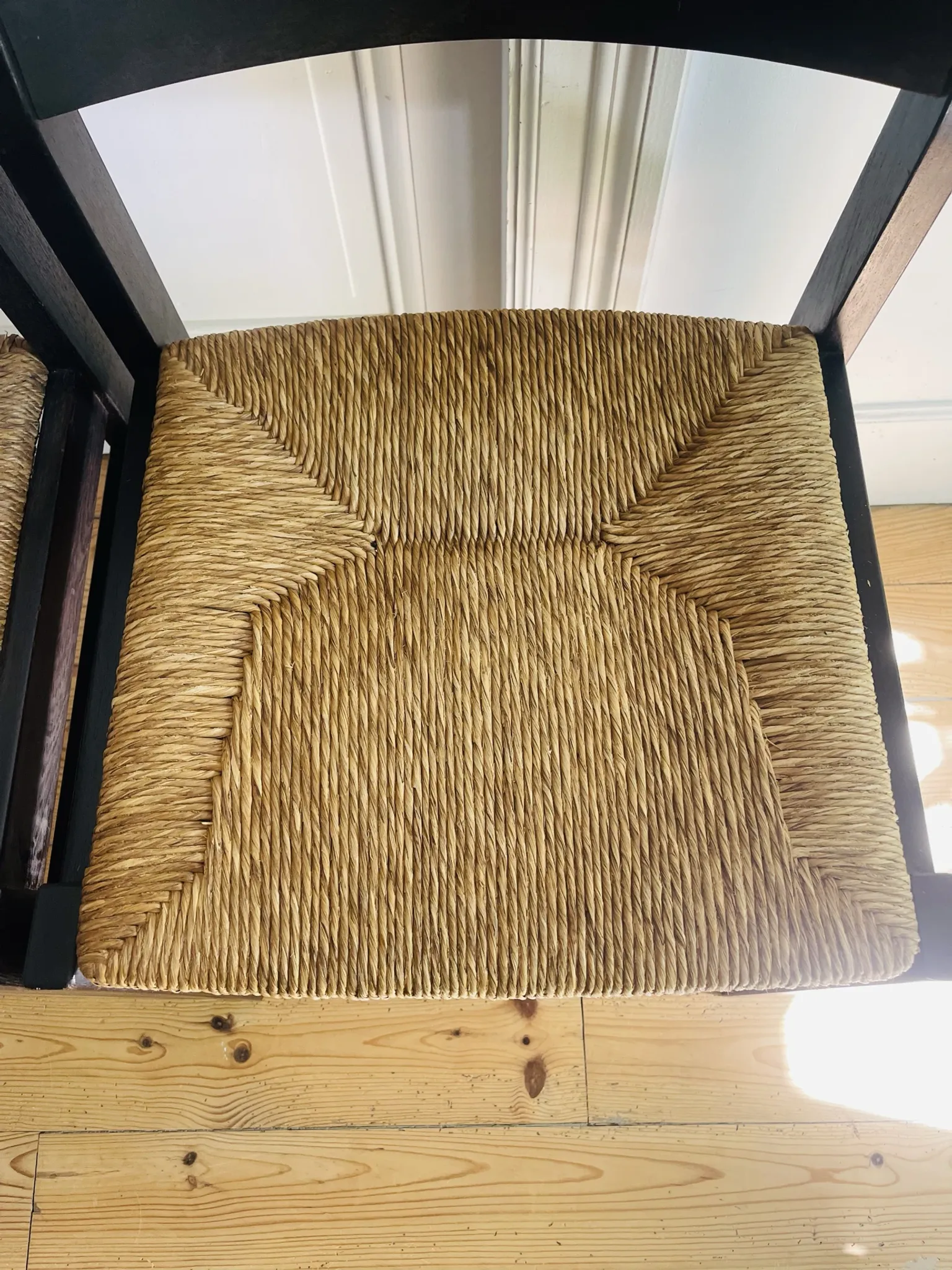 Pair of straw-seated wooden chairs in the regain style.