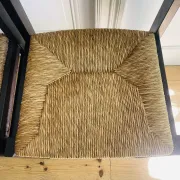 Pair of straw-seated wooden chairs in the regain style.