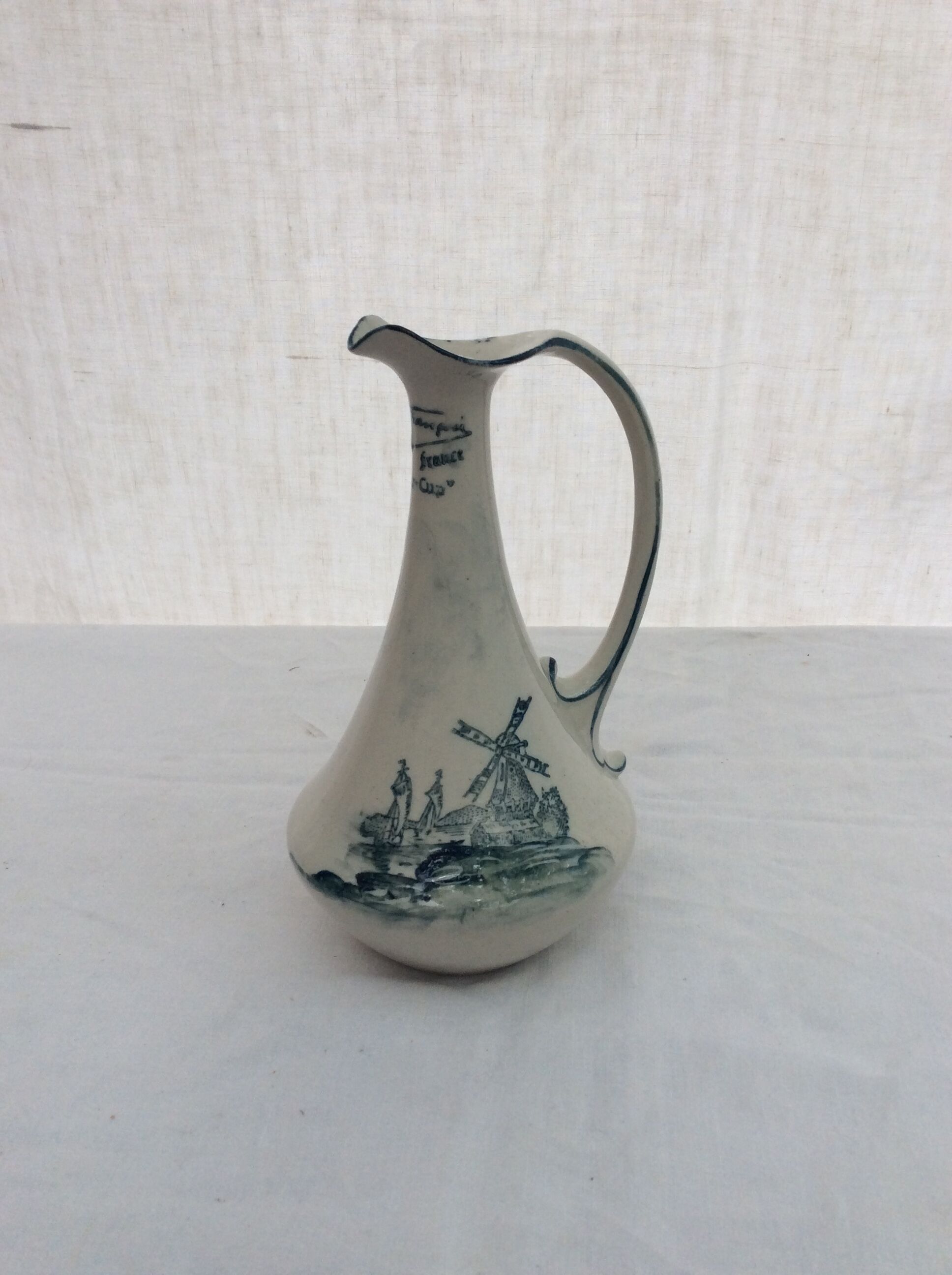 Old pitcher in Dutch-made earthenware signed
