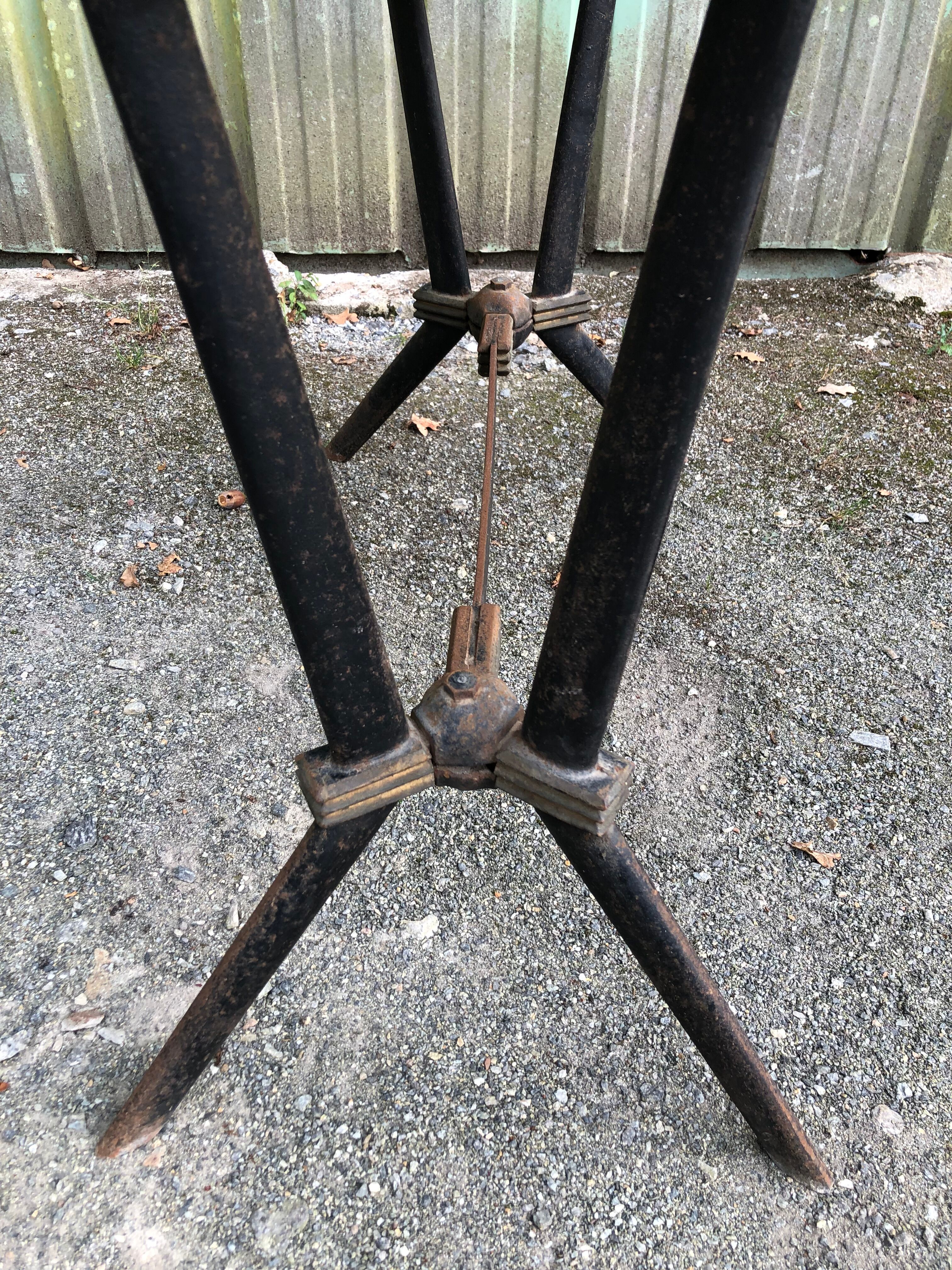 Vintage bistro table with an Art Deco style cast iron base and Formica top.
