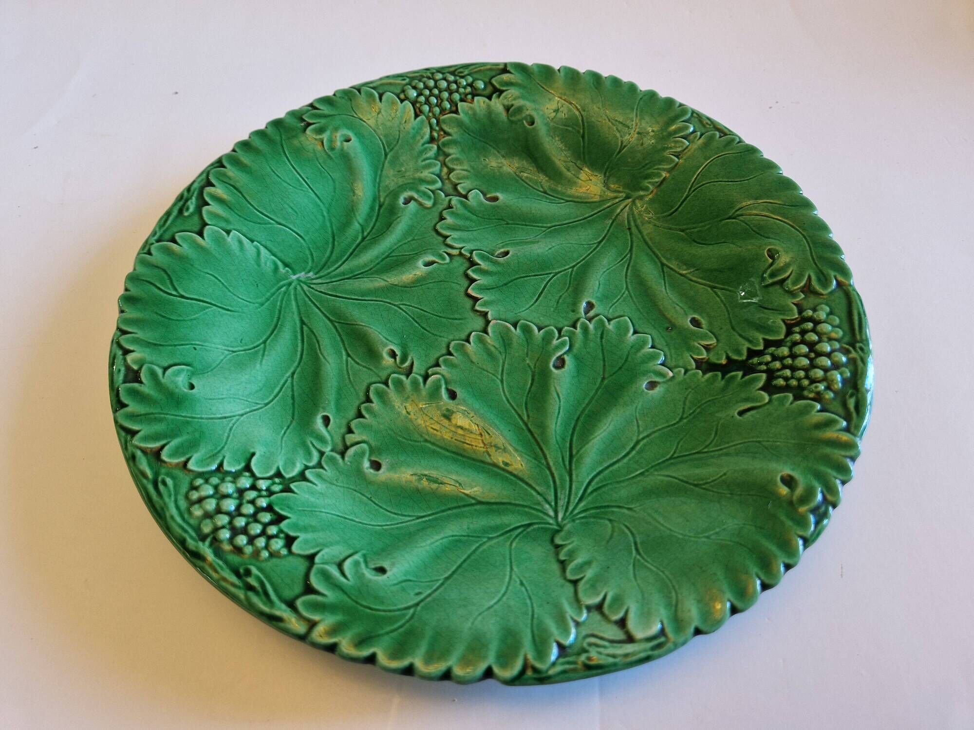 8 green barbotine plates from the early 20th century.