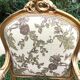 Pair of straight-backed armchairs, known as "queen's armchairs," in carved and gilded wood