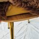Vintage shaggy chair in faux fur with golden metal legs.