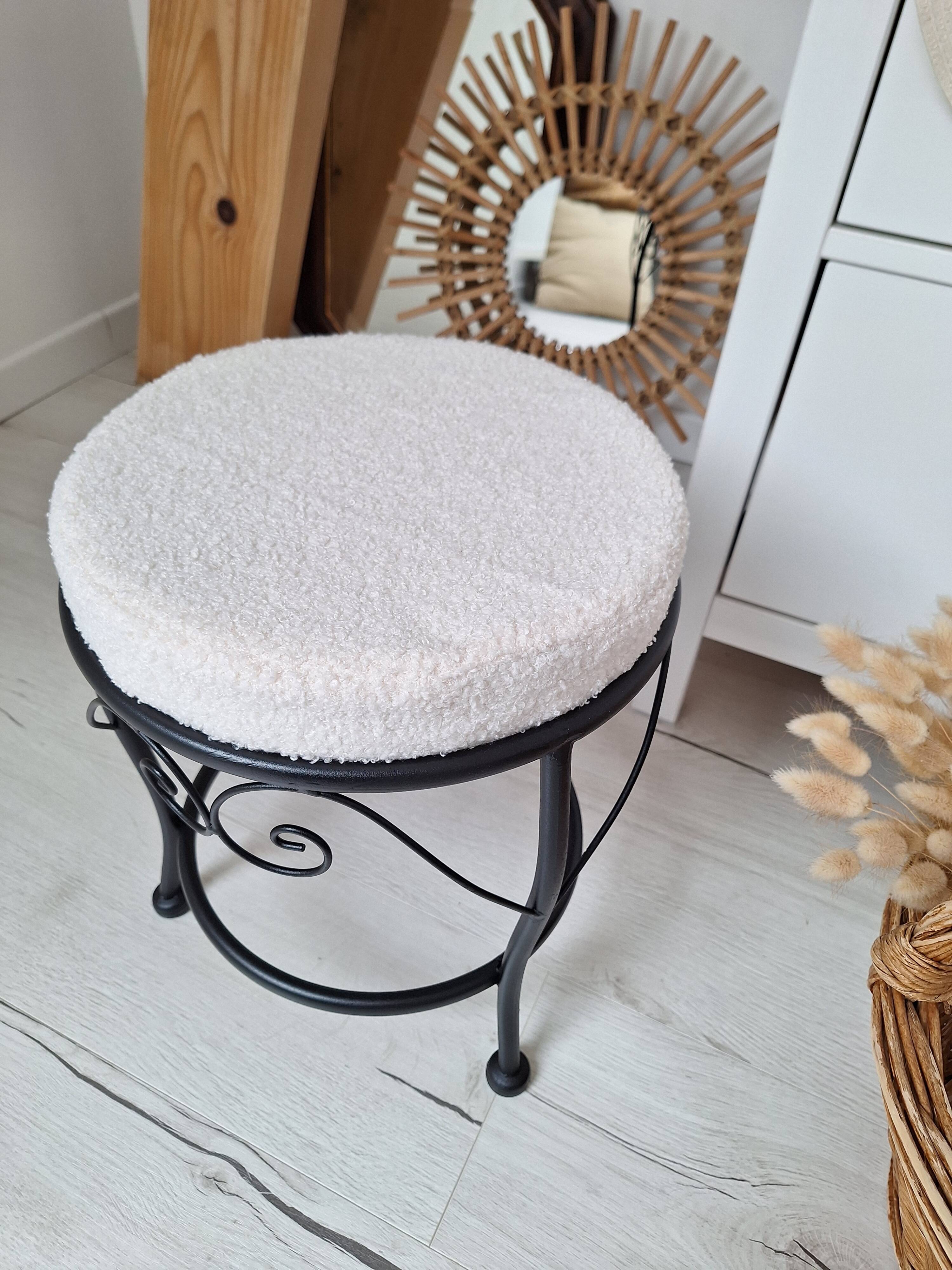 Black iron stool/pouf with its boucle fabric cushion.