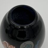 Double-lined blown glass vase with flower inclusions.