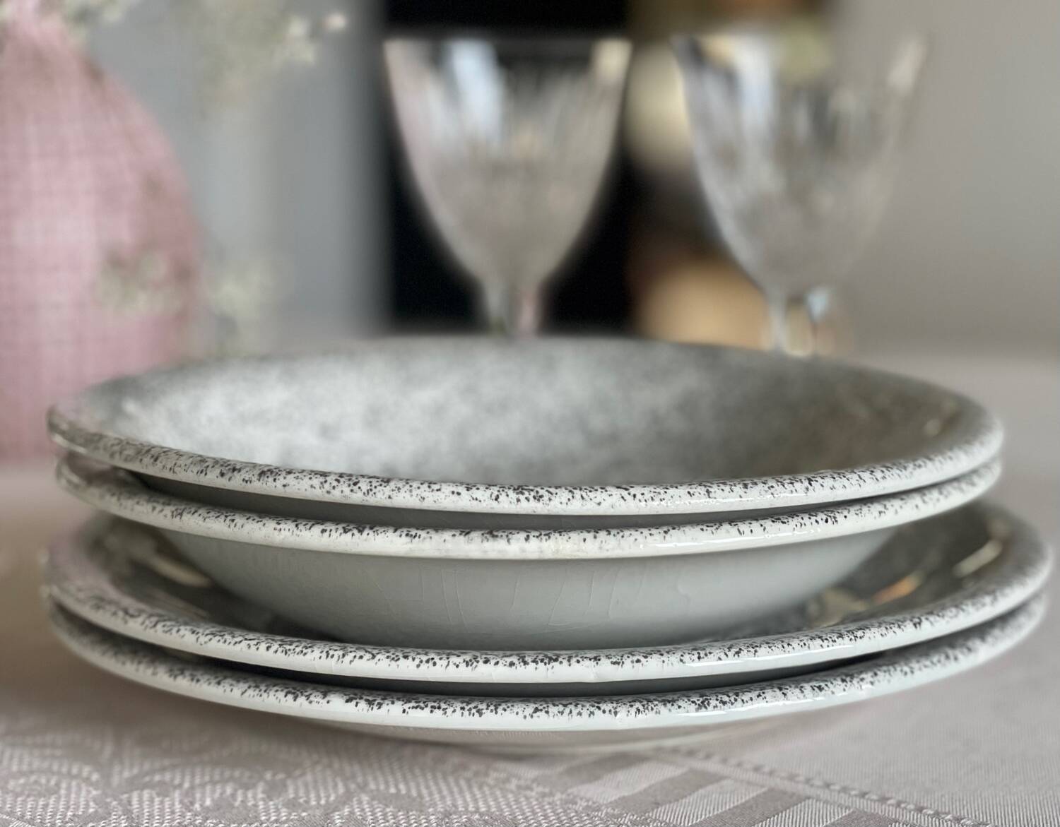 12 speckled ceramic plates.