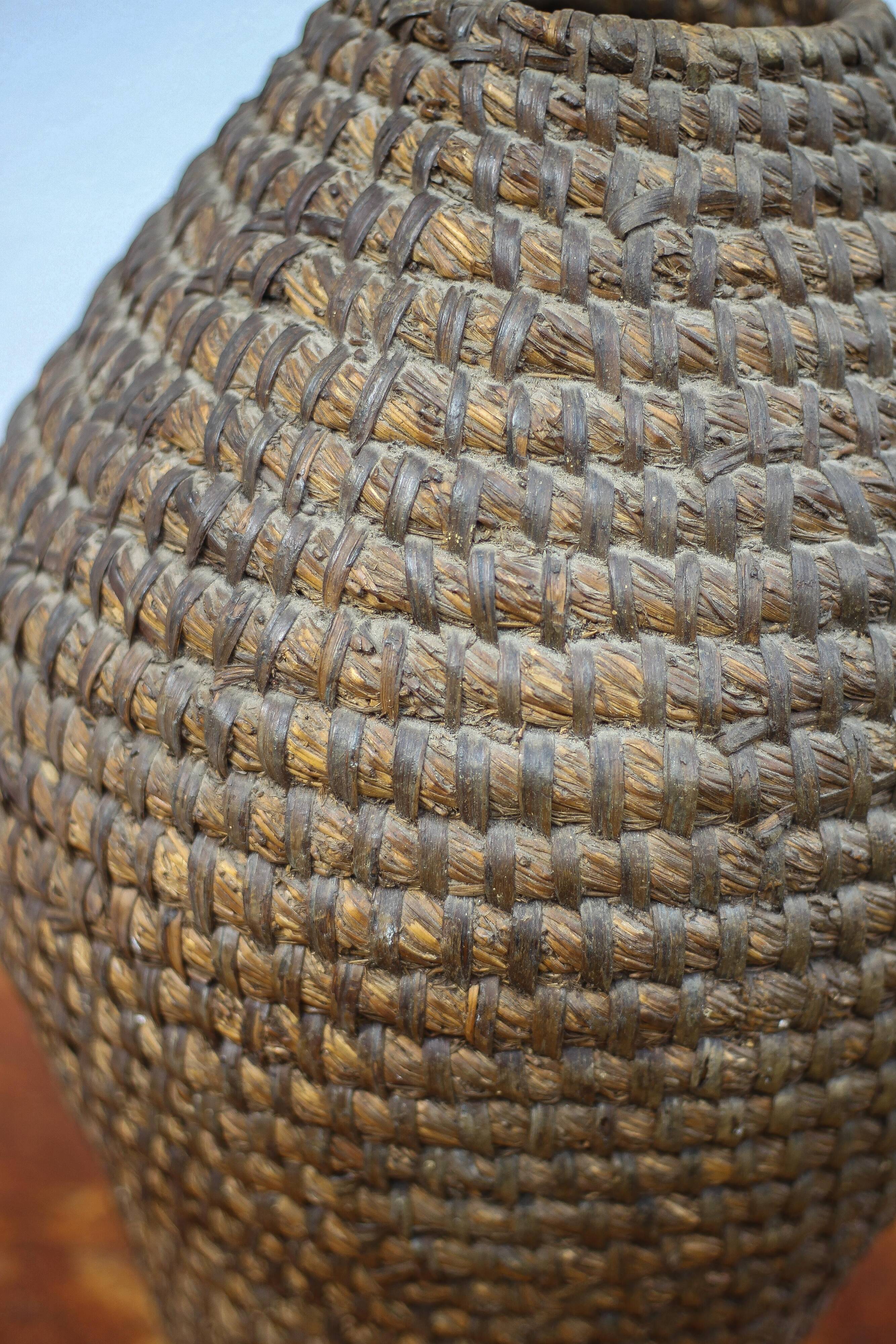 Old basket, burgundy straw and bramble, woven basket, interior decoration