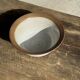 Small thick stoneware bowl with a stylised flower pattern in white on the outside, b