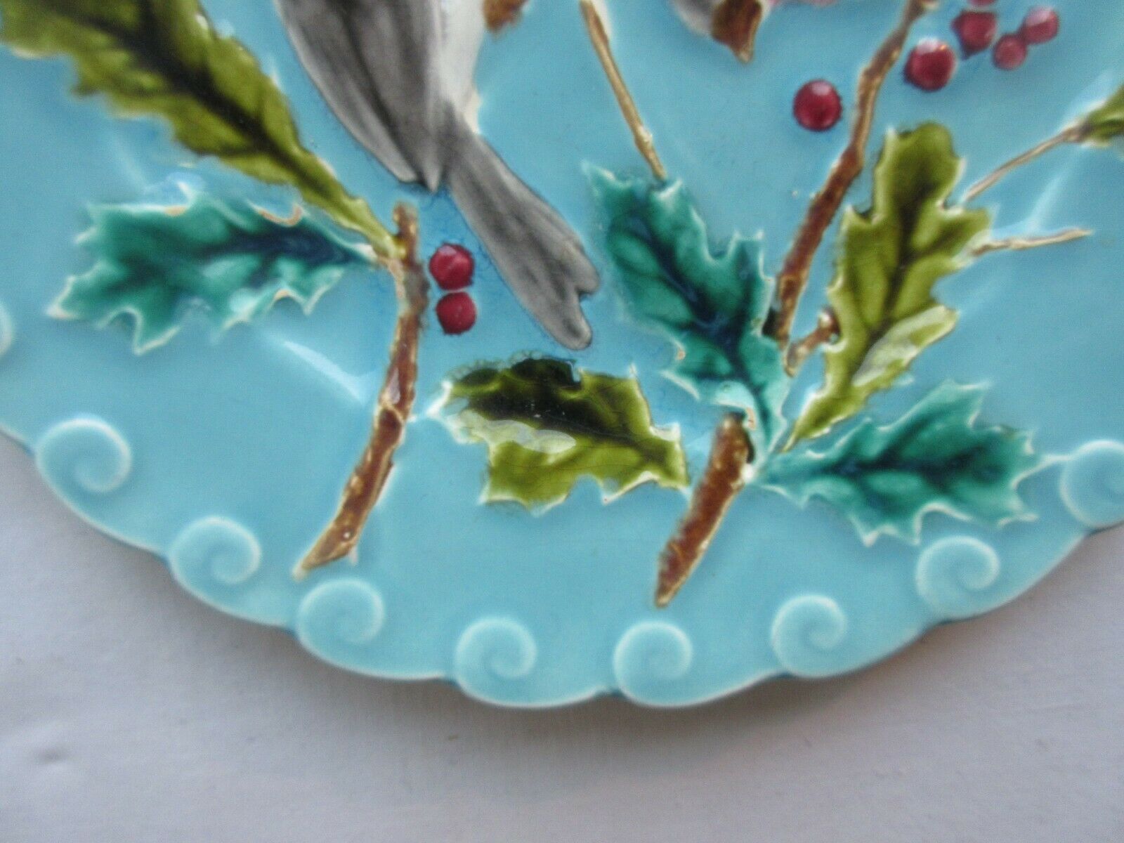 Blue barbotine plate of Sarreguemines: Birds pecking with holly
