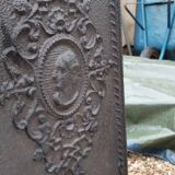 Black cast iron wood burning stove with solid brass handle.