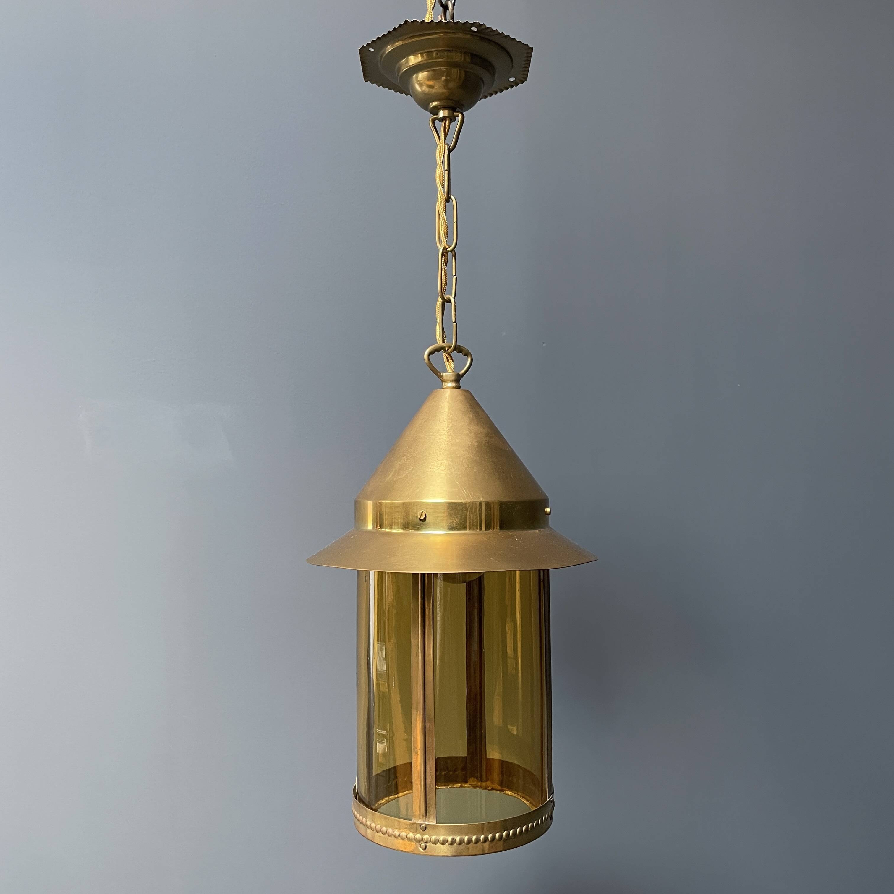 Brass lantern pendant lamp with yellow glass