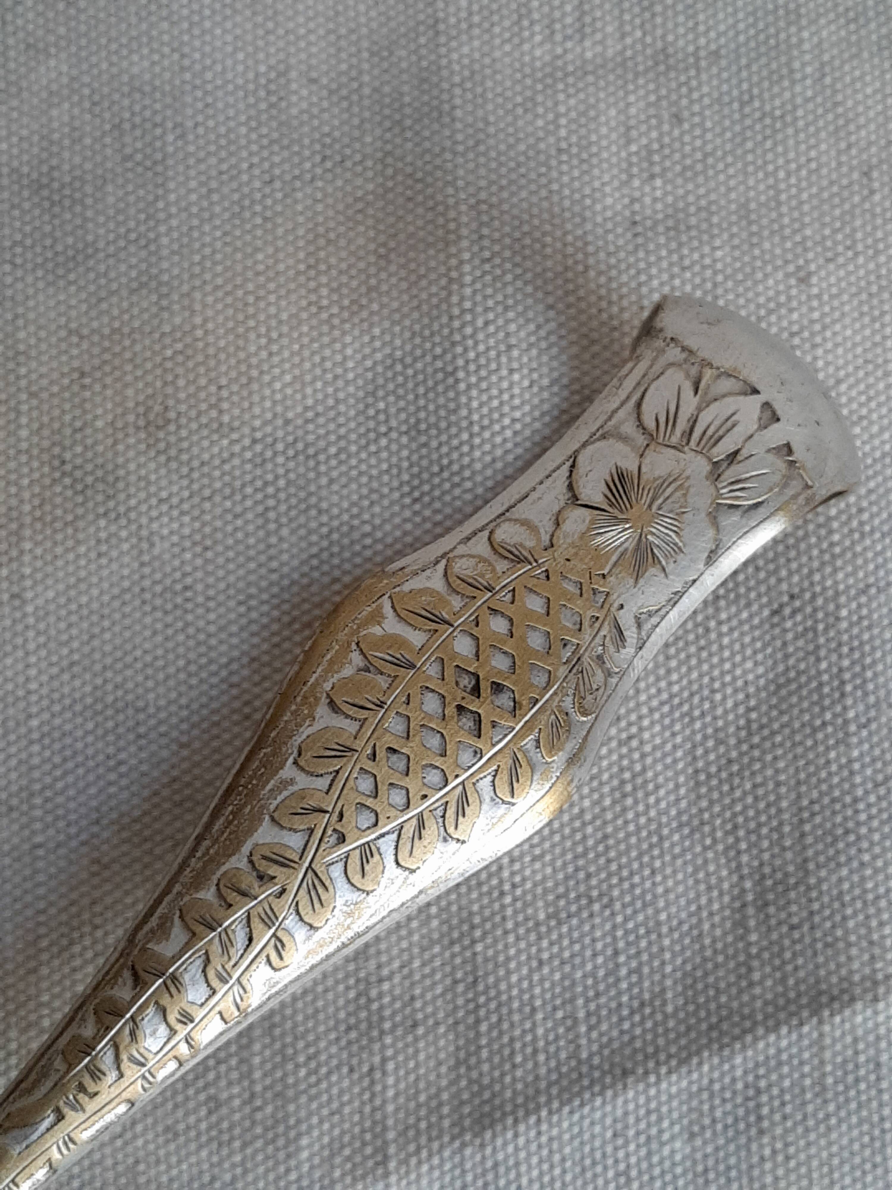 Antique silver-plated sugar tongs with lion's paws.