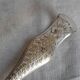 Antique silver-plated sugar tongs with lion's paws.