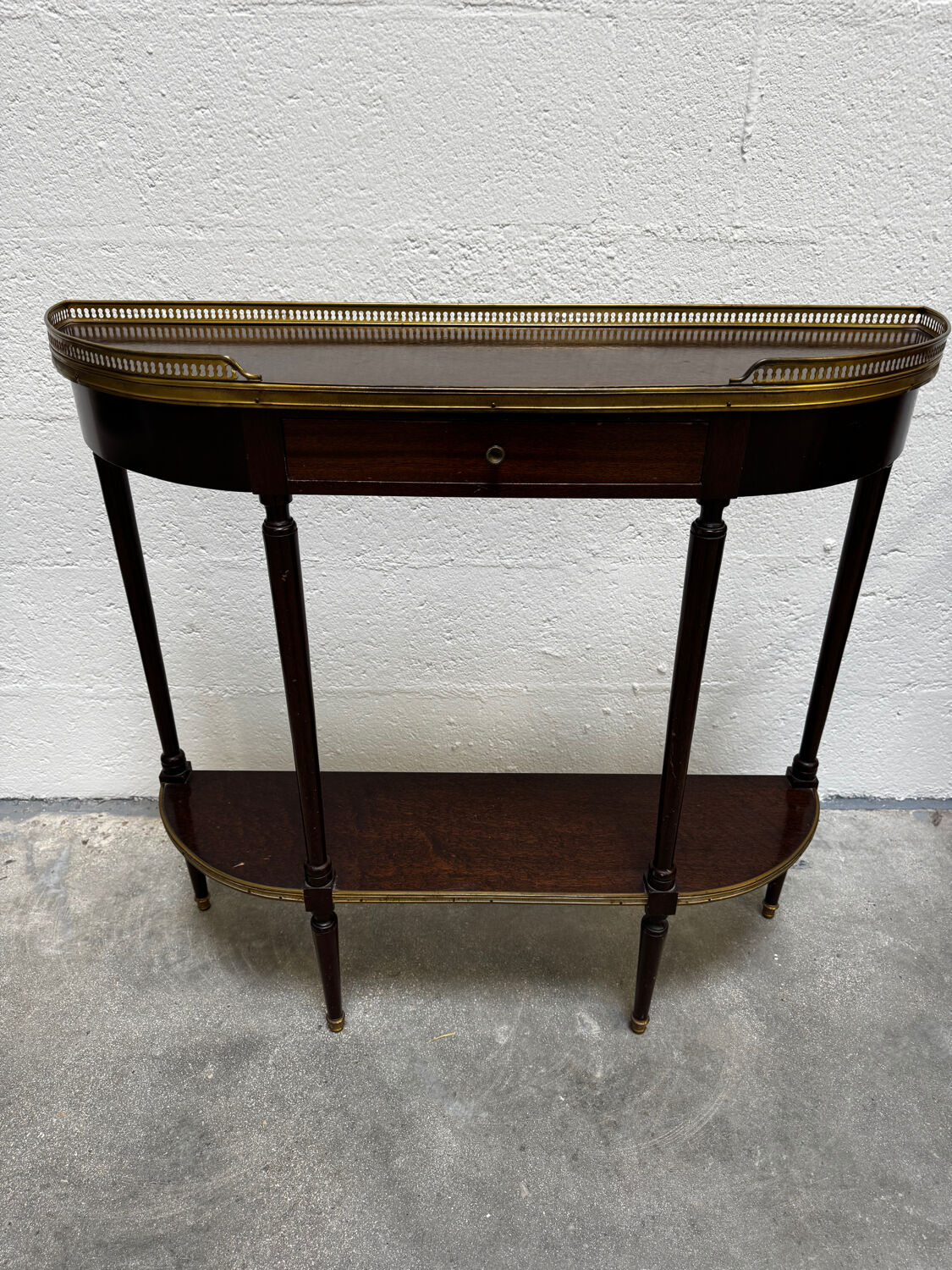 Louis XVI demi-moon console in wood and brass.
