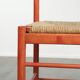 Nice red vintage wooden chair from the 1970s with a woven wicker seat