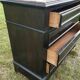 Blackened wooden chest of drawers with 5 drawers