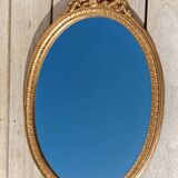 Authentic chic vintage oval mirror, in gilded wood, in baroque style.