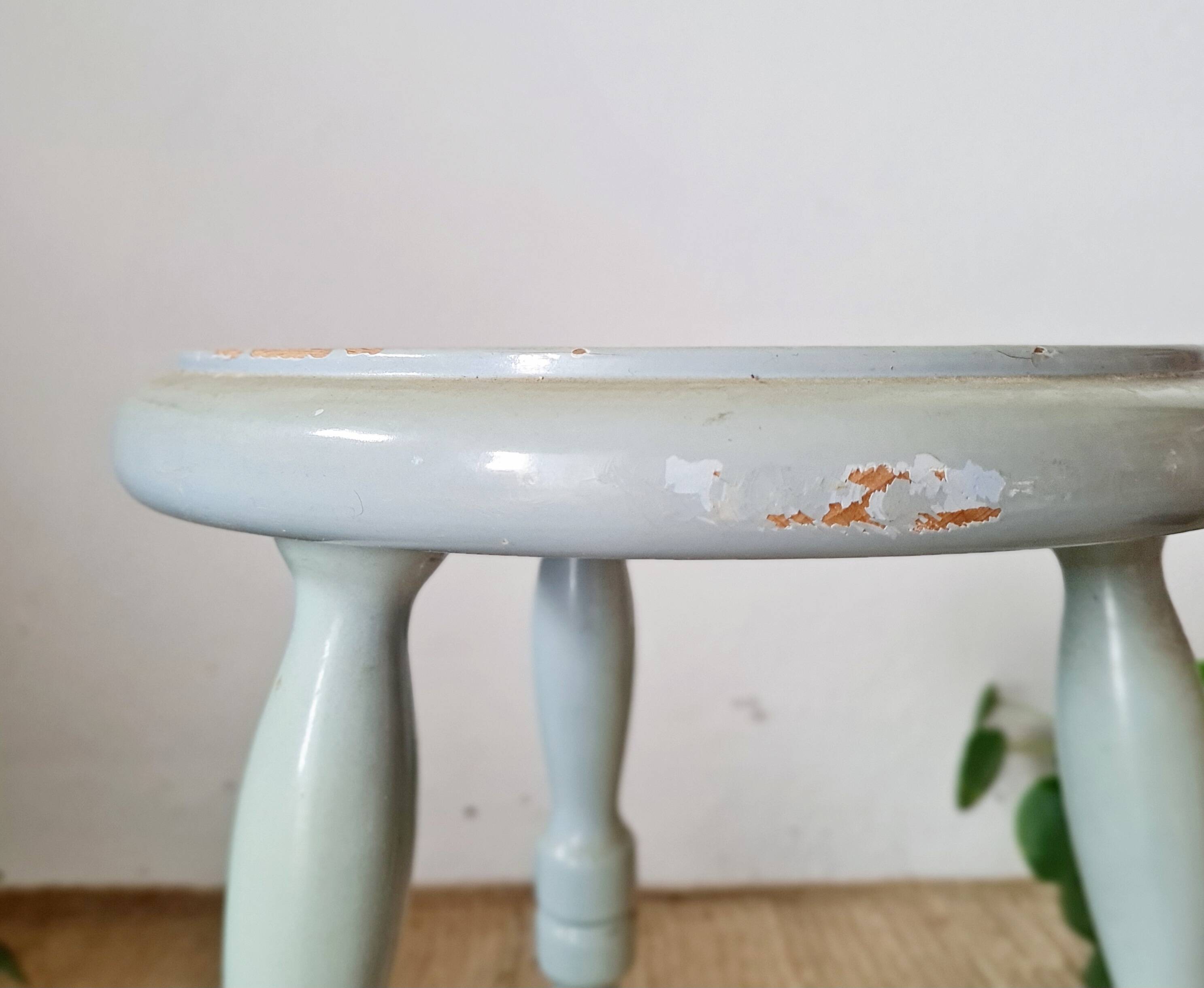 Antique tripod stool made of solid wood in blue.