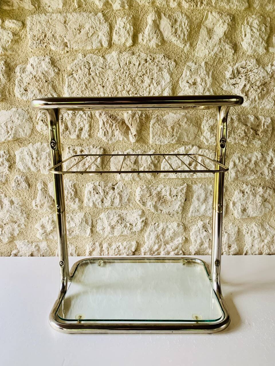 Glass and brass side table with magazine rack, circa 1970's