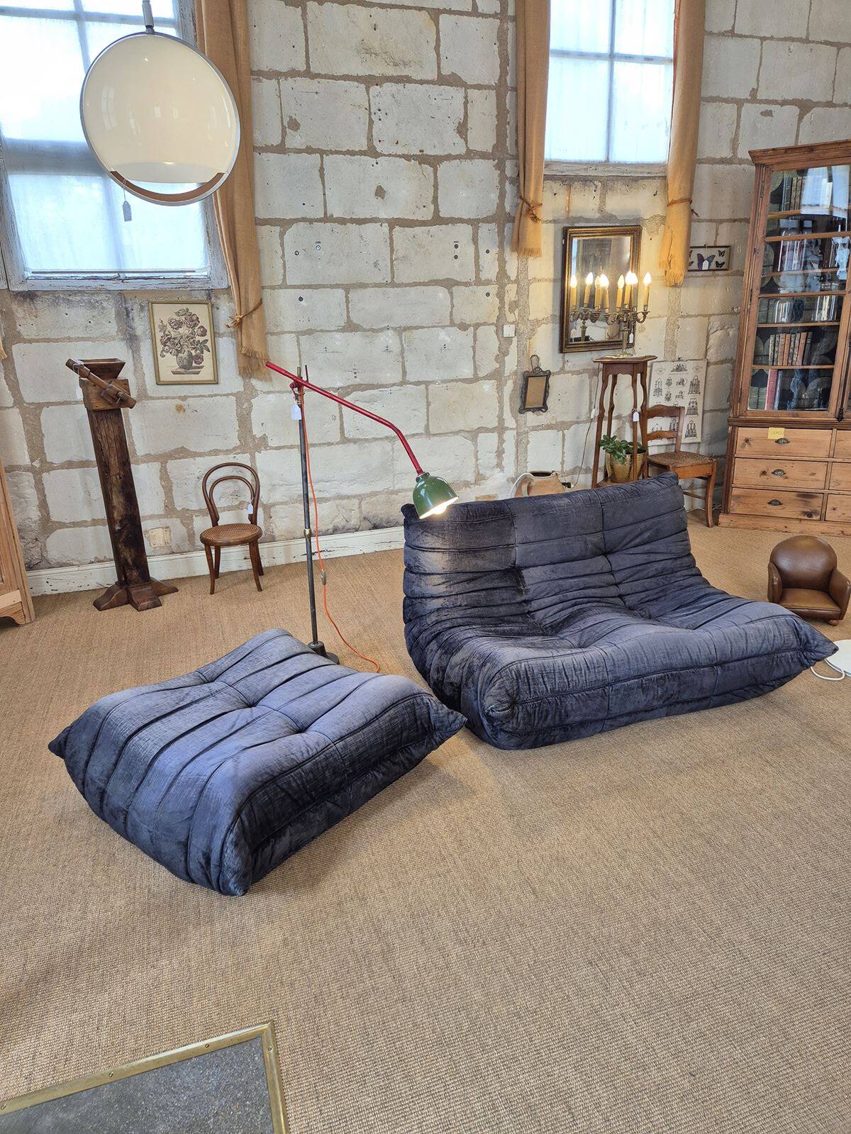Togo sofa by Ligne Roset and its pouf from the 1970s.