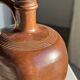 Ancient stoneware jug with a pewter spout.