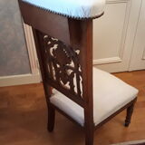 Prie-god furniture in the shape of a low seat with an armnedle on which one kneels to pray
