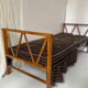Two-seater bench convertible into a single bed.