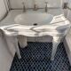 Set of a sink and its retro ceramic splashback.