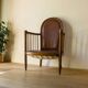 Antique armchair in solid wood and patinated brown leather, early 20th century.