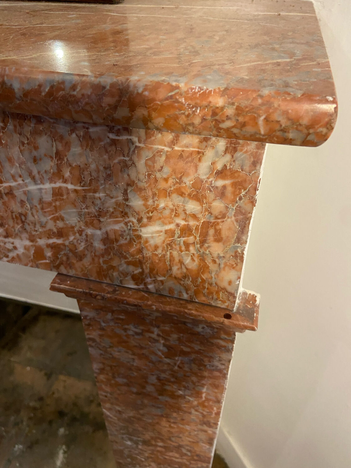 Marble fireplace surround with closed hearth frame.