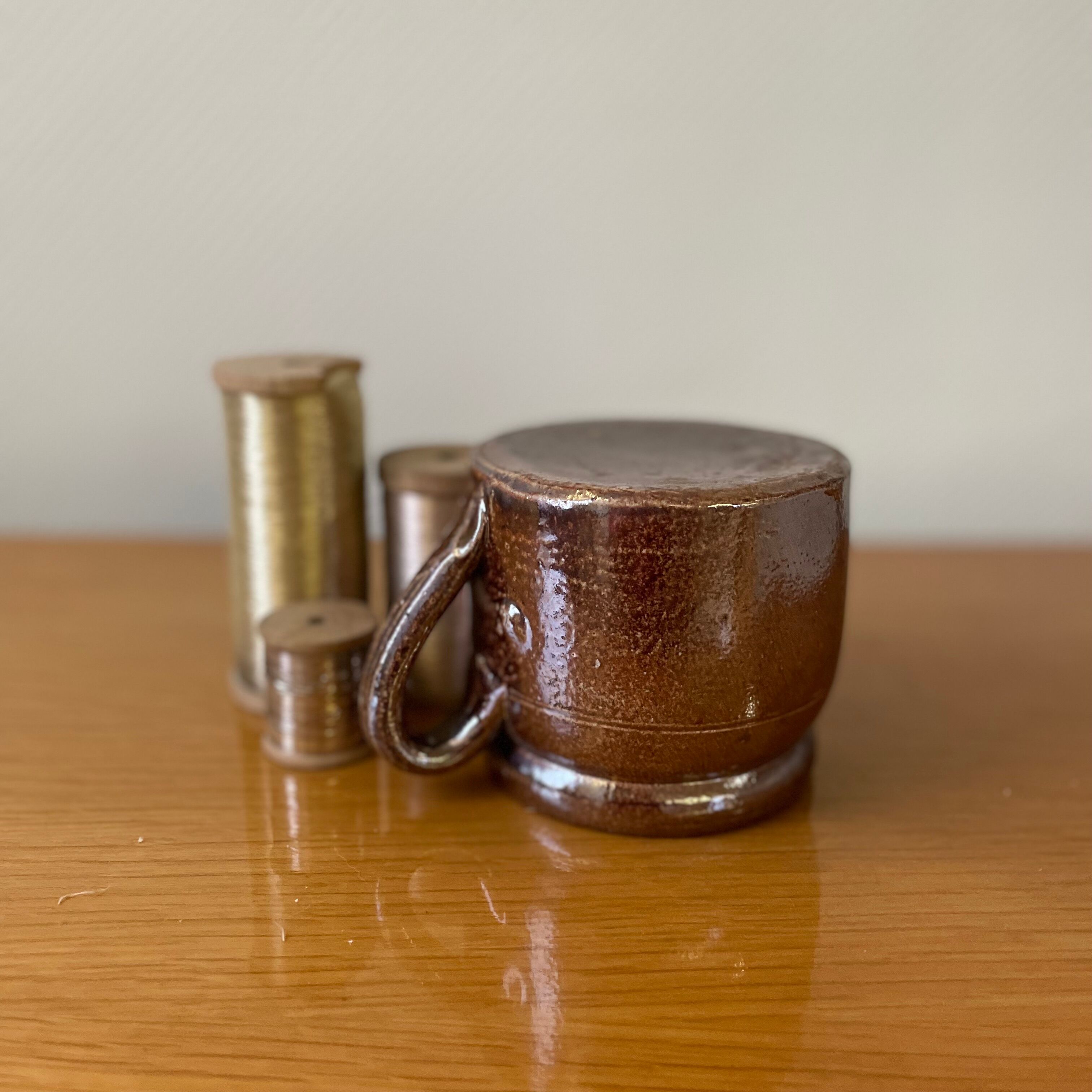 Stoneware pot with glossy glazed brown and vintage speckled gray handle