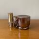 Stoneware pot with glossy glazed brown and vintage speckled gray handle