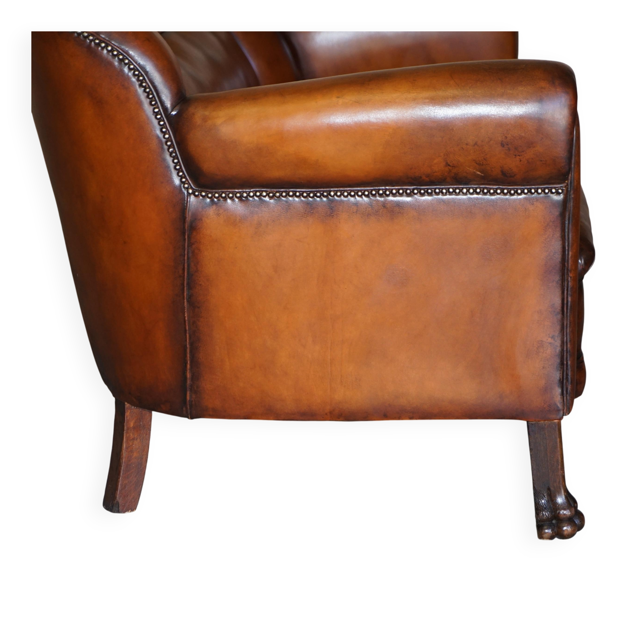 Victorian Chesterfield leather canapé with oak lion claw feet.