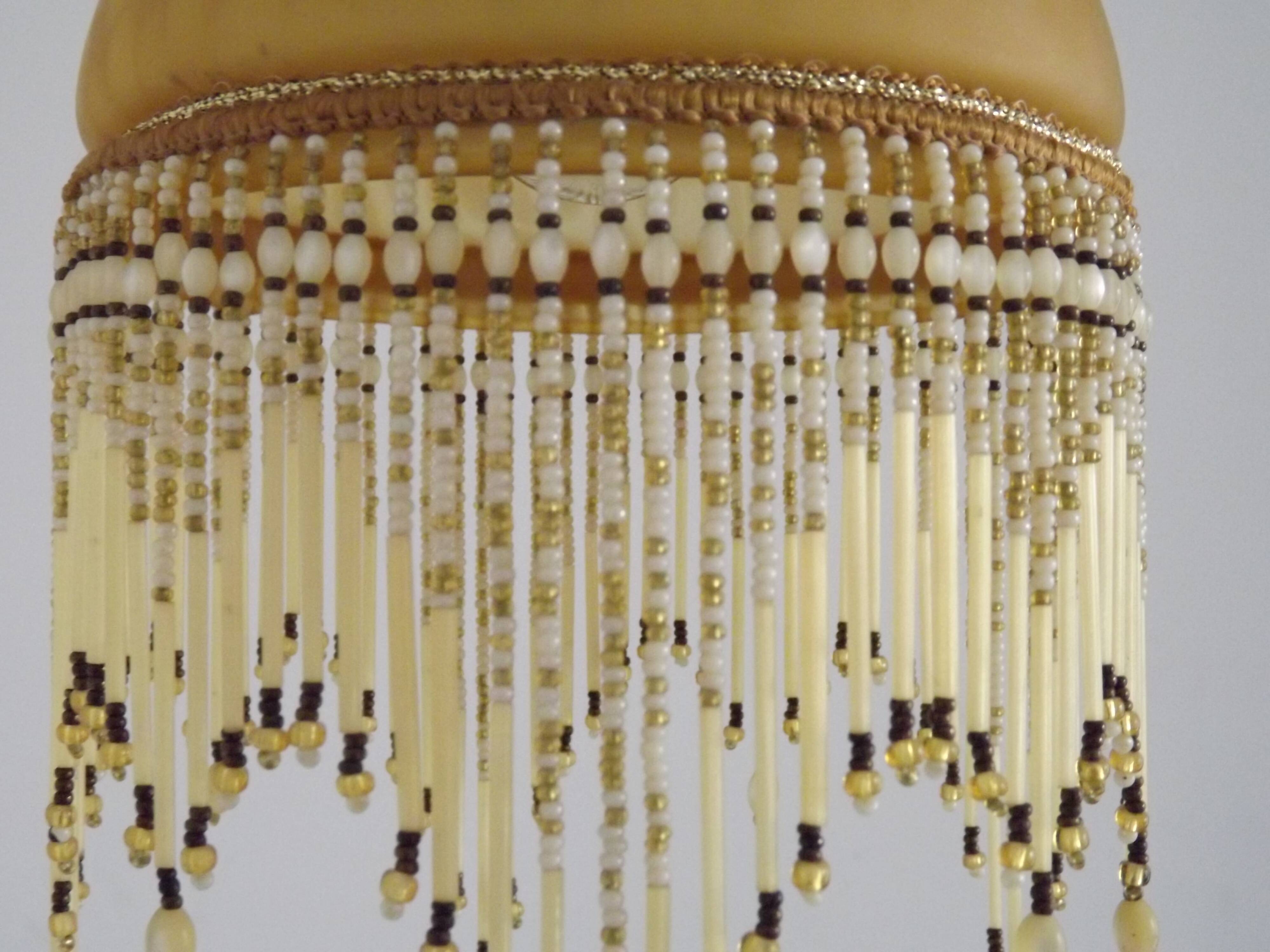 Vintage French amber mottled glass hanging ceiling light with beaded fringe.