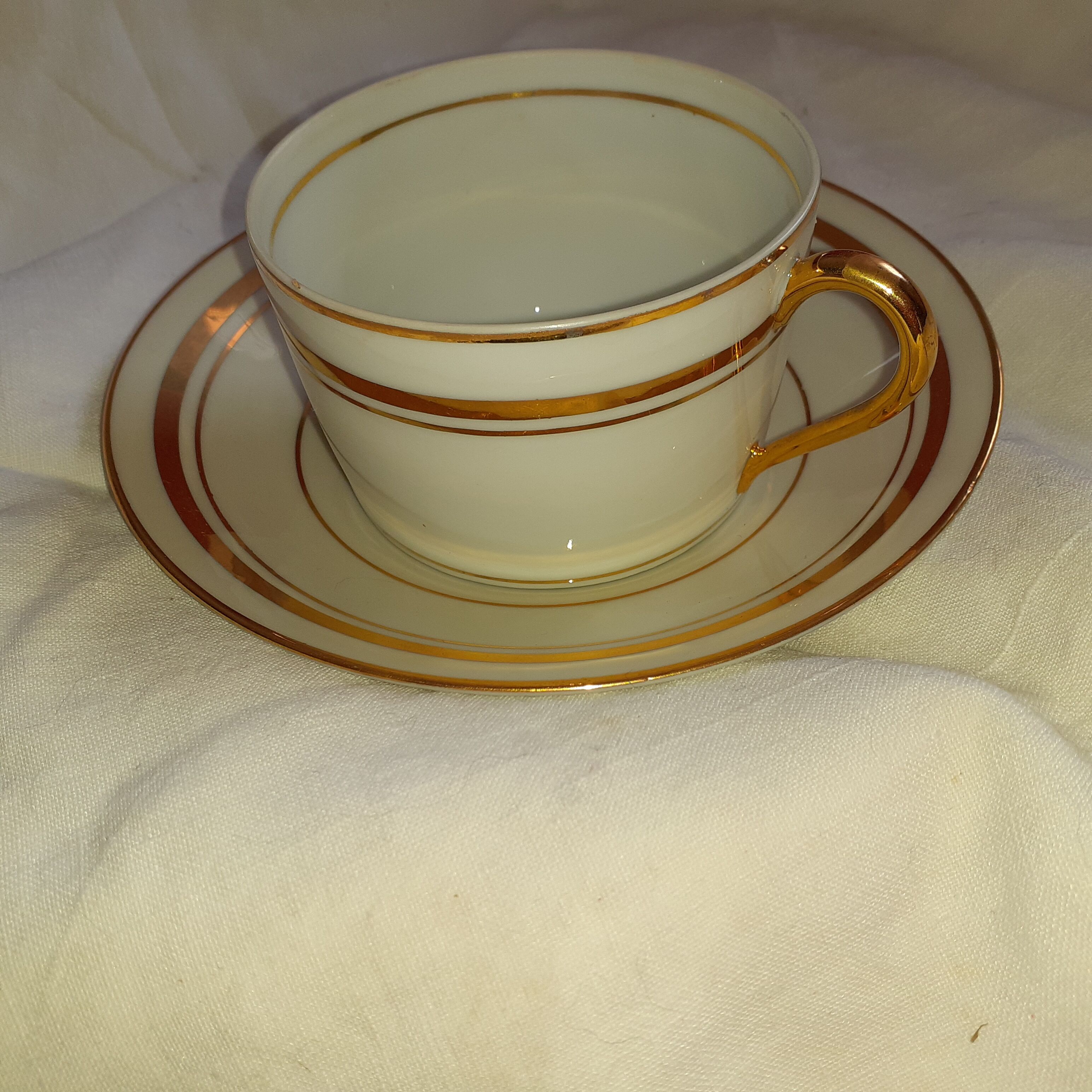 6 white cups and their limoges porcelain saucers. Signed Giroud.
