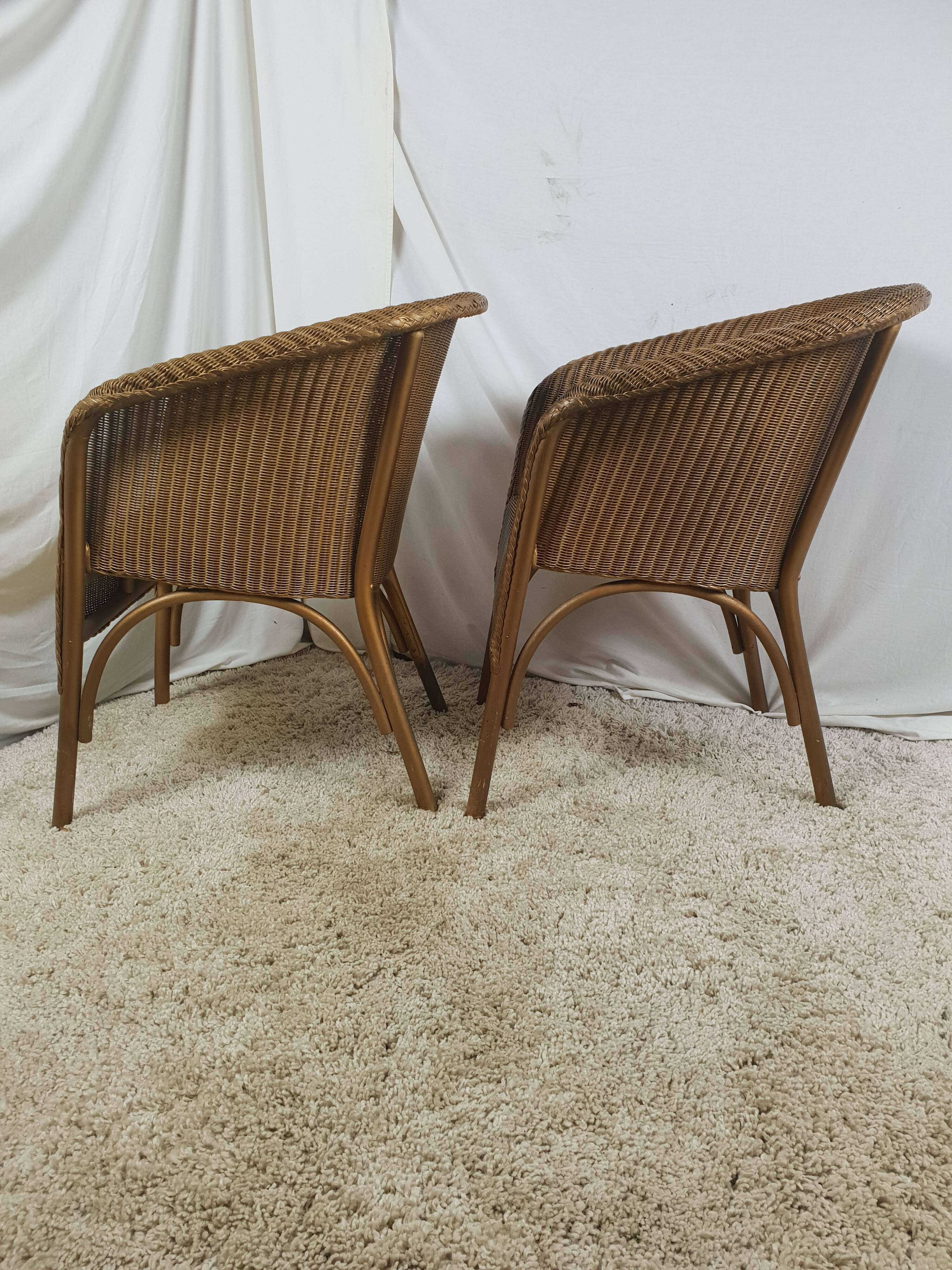 Paire de fauteuil Lloyd Loom doré