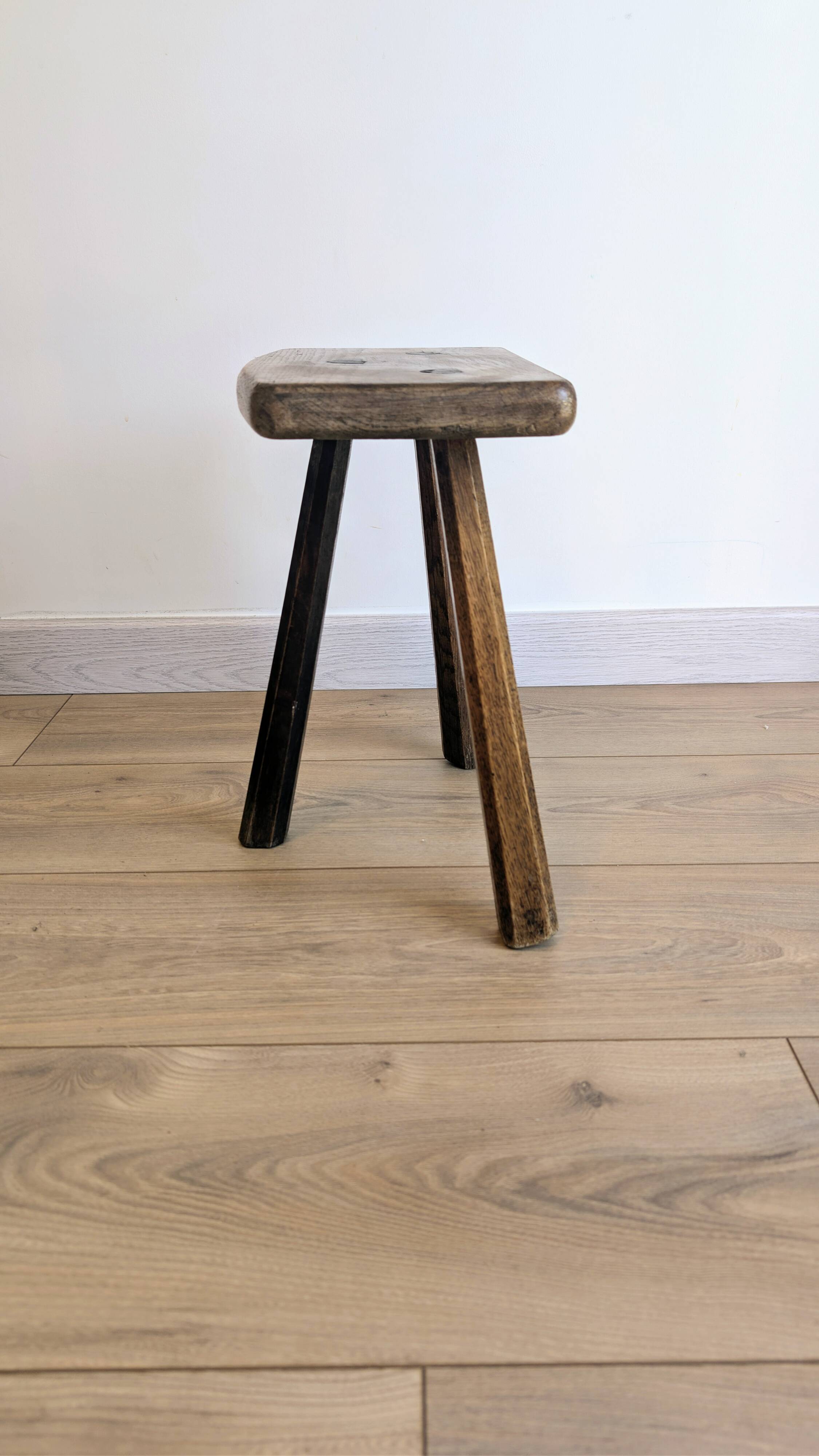 Antique tripod stool in patinated solid wood