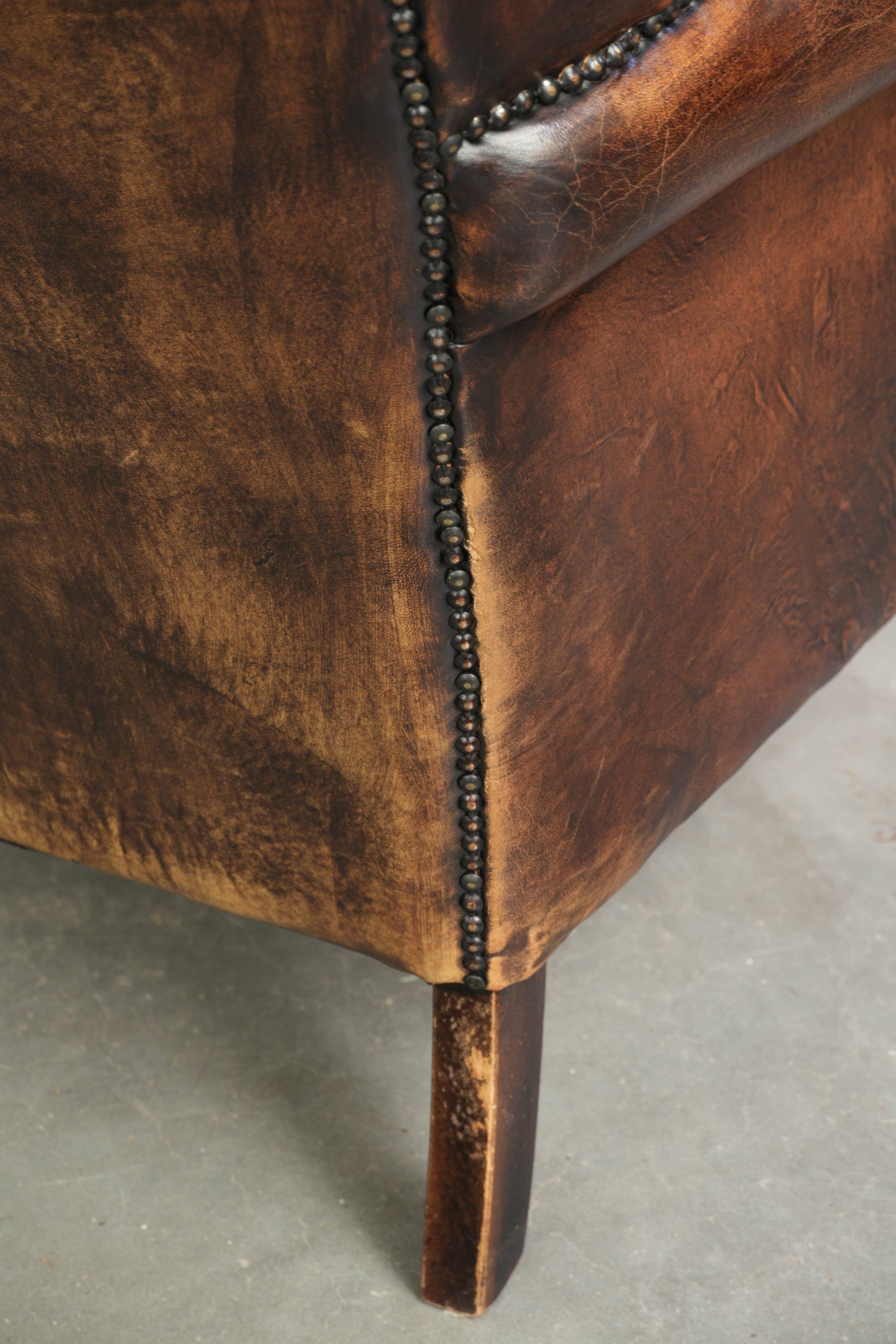 Vintage sheepskin wingback armchair in a deep brown colour finished