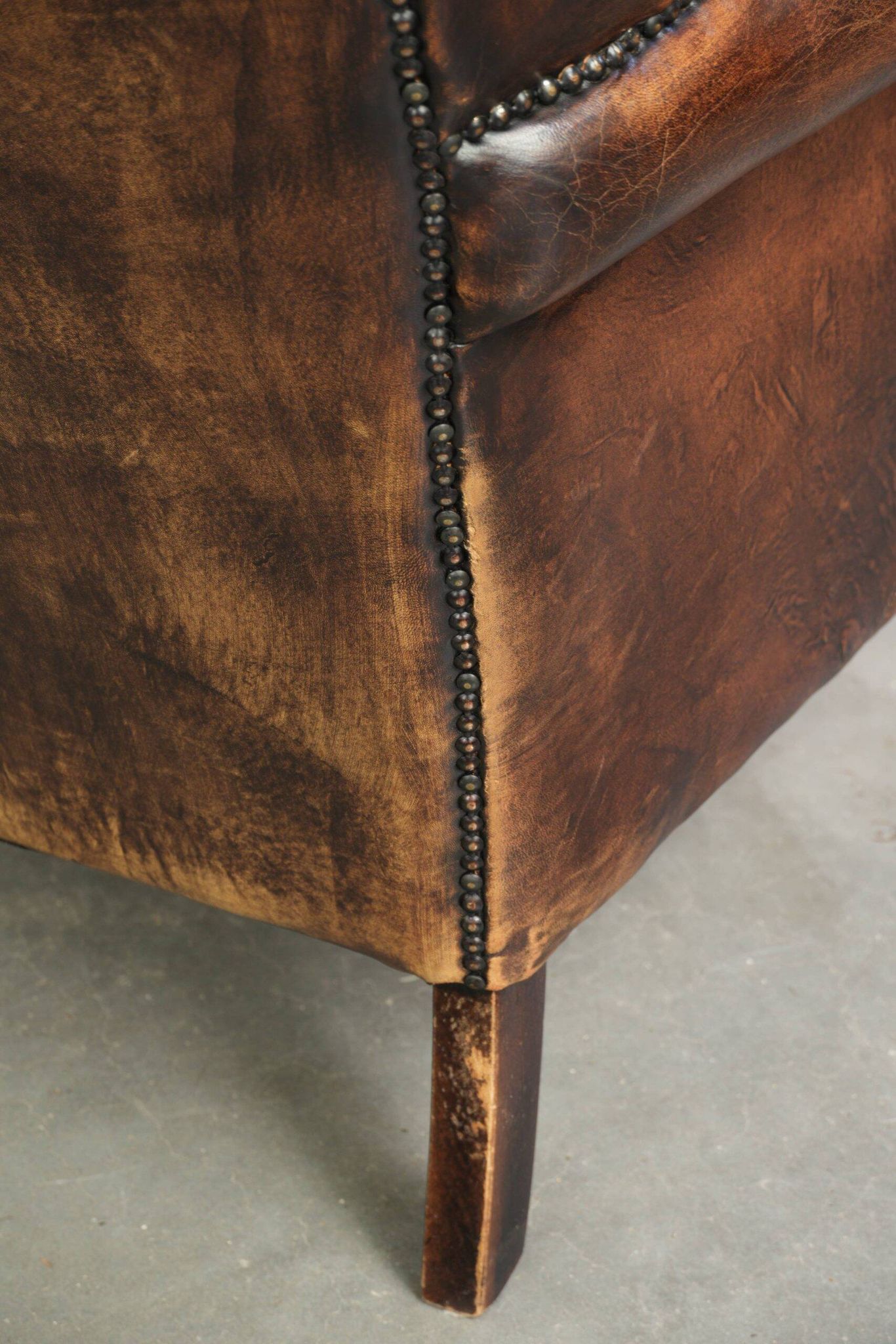 Vintage sheepskin wingback armchair in a deep brown colour finished